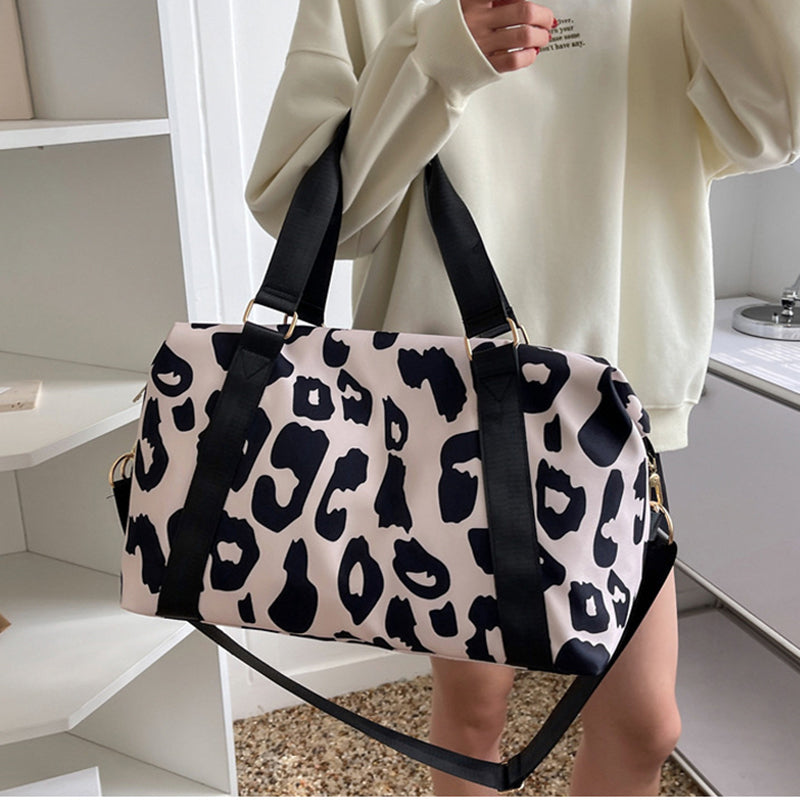 Moo-ve in Style: embrace the Bovine Chic with our Playful Cow Print Overnight Bag!
